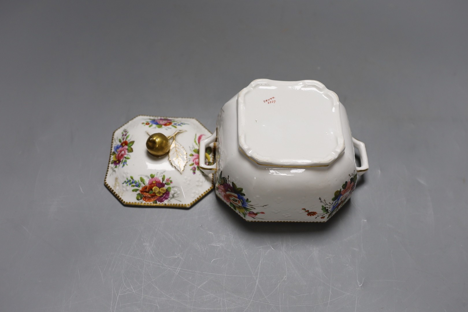 A Spode sugar box and cover of moulded form painted with flowers having a fruit finial, marked Spode 2527. 16cm